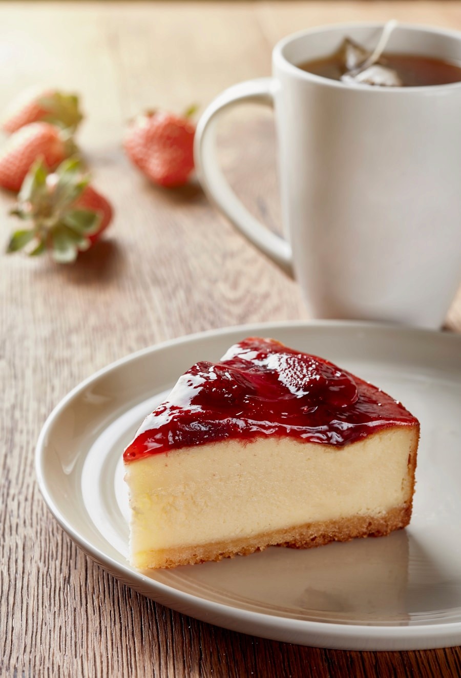 A slice of strawberry cheesecake on a plate
