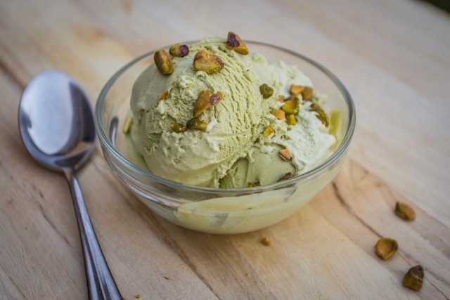 Pistachio gelato served in a clear glass bowl