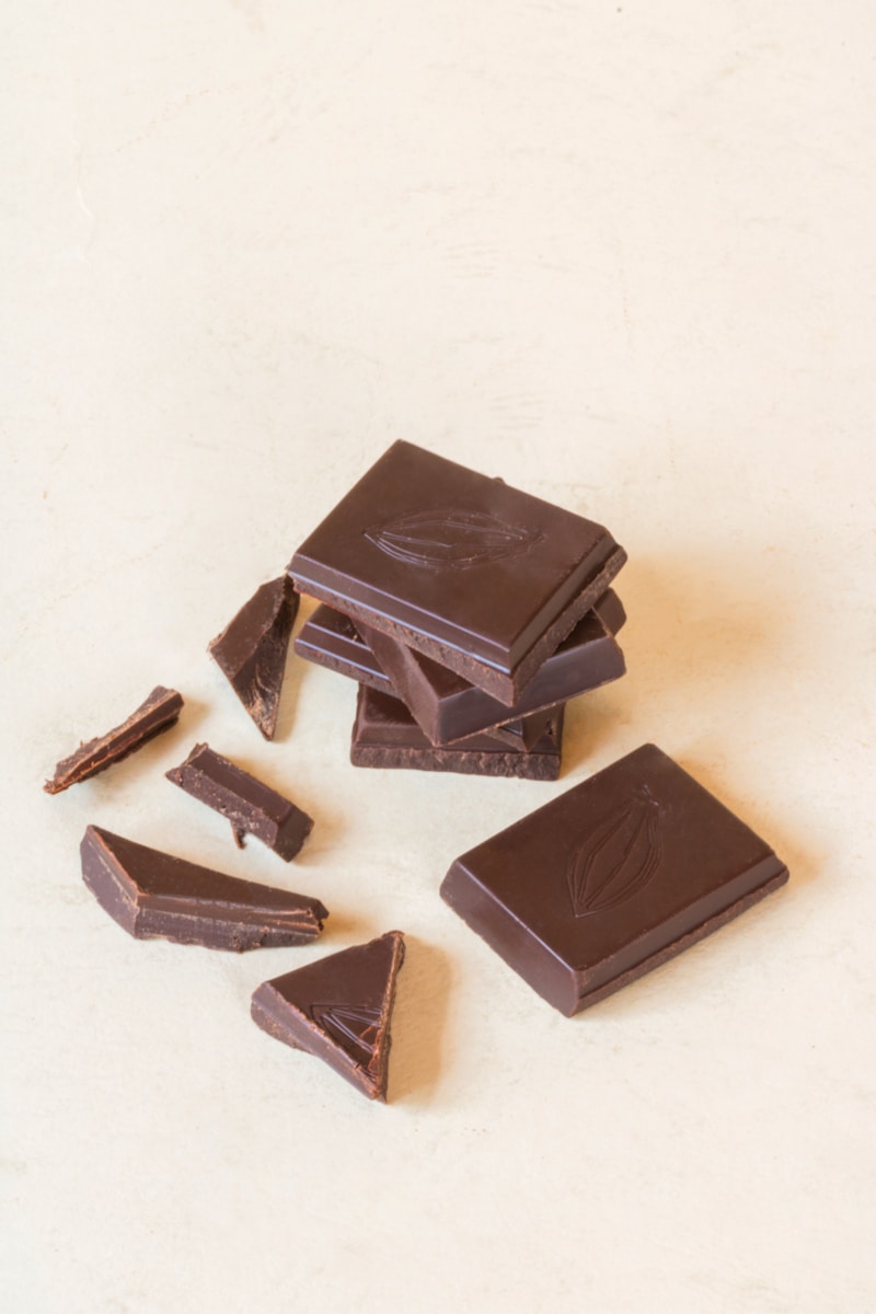 Pieces of dark chocolate scattered on a table